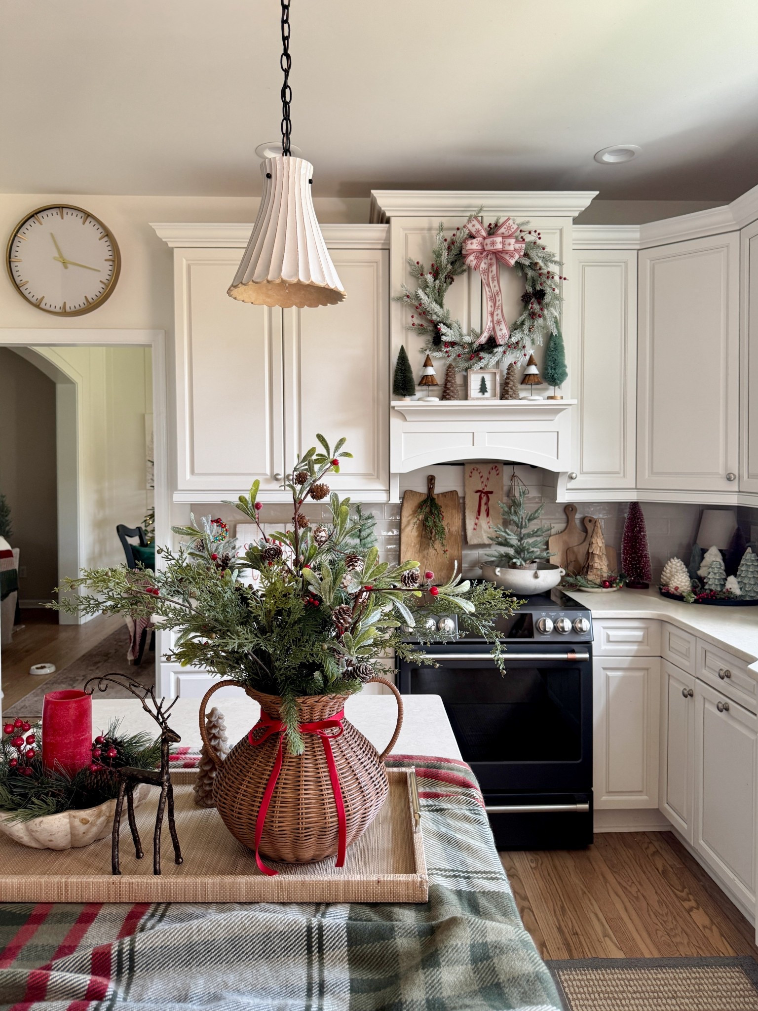 My favorite woven vase and a very similar one for lots less $. Cedar stems. Cast aluminum deer. Collected aged bread board. Scalloped bowl. Flameless Christmas trees and pinecone candles. White scalloped pendant lighting. Cafe 30” stove  

#LTKGiftGuide #LTKHome #LTKHoliday