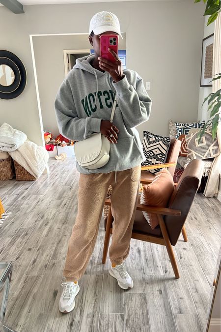 Cozy casual outfit for running errands. Grey hoodie, tan faux shearling joggers, white new balance 237 sneakers, white Ganni crossbody purse and white graphic baseball hat  

#LTKtravel #LTKstyletip #LTKfit