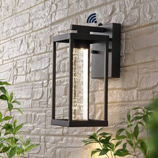 Juno 4.75 in. Black Hardwired Outdoor Cylinder Sconce Iron/Seeded Glass with Dusk-to-Dawn Sensor Integrated LED 1-Light | The Home Depot