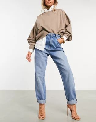 ASOS DESIGN high rise 'slouchy' mom jeans in midwash | ASOS (Global)