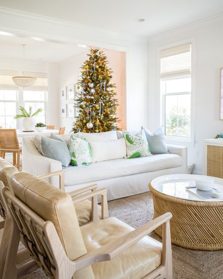 Our Christmas living room and dining room decorated with shades of blue and green! Our 9’ artificial Christmas tree is decorated with blue velvet bows, gold starburst ornaments and blue and green round ornaments. Also linking our linen sofas, light camel leather chairs, rattan dining chairs, square patterned jute rug and seagrass tree collar. See our full Christmas home tour here: https://lifeonvirginiastreet.com/2022-christmas-home-tour/.
.
#ltkhome #ltkholiday #ltkseasonal #ltksalelaert #ltkunder50 #ltkunder100 #ltkstyletip

#LTKsalealert #LTKHoliday #LTKhome