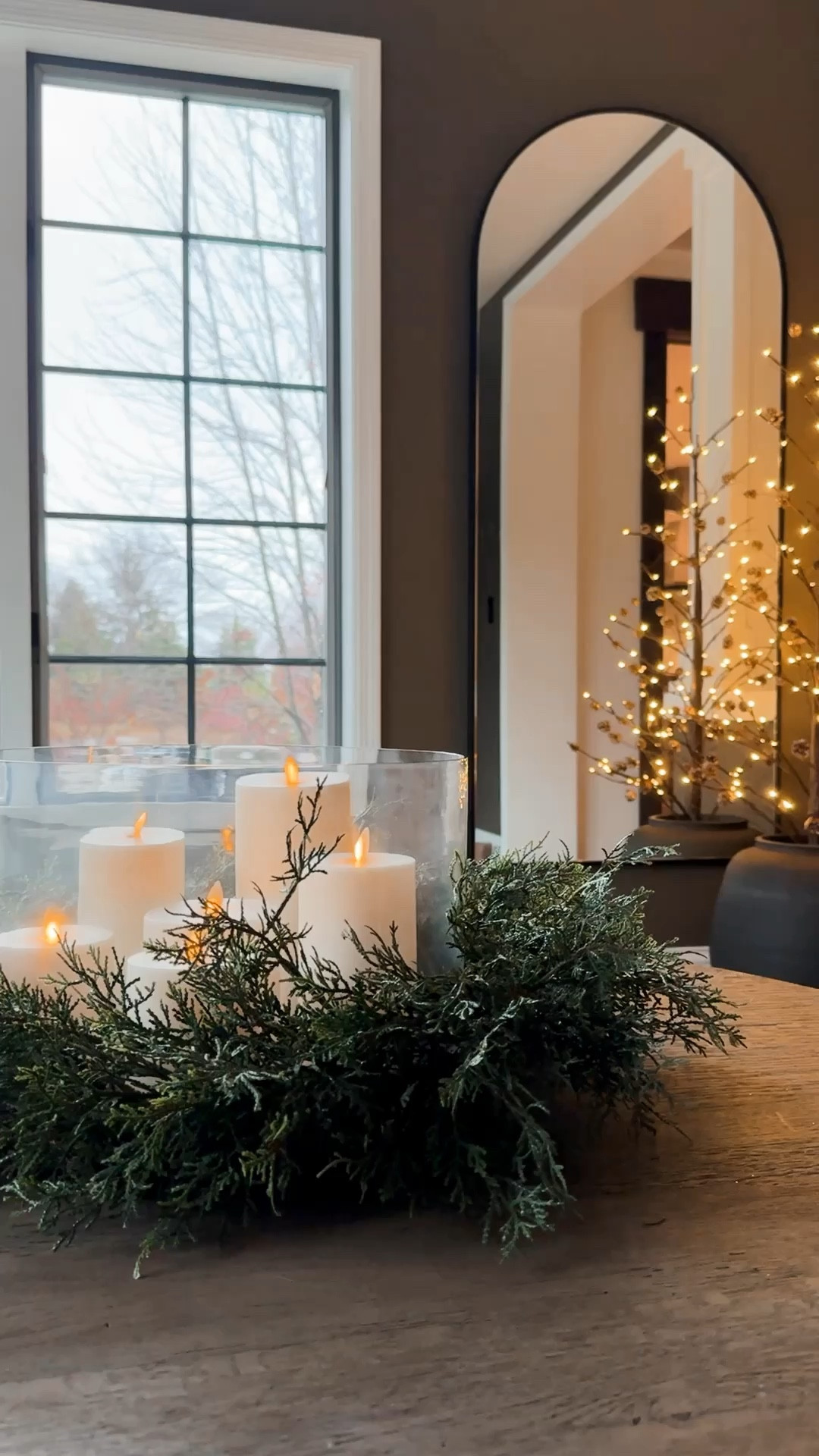 Table centerpiece idea. One of my favorite ways to create a simple yet beautiful holiday centerpiece is to use a wreath or greenery with a hurricane and candles in the middle. You could also achieve the look with a beautiful tray and set the candles on top.￼

#LTKVideo #LTKHome #LTKHoliday