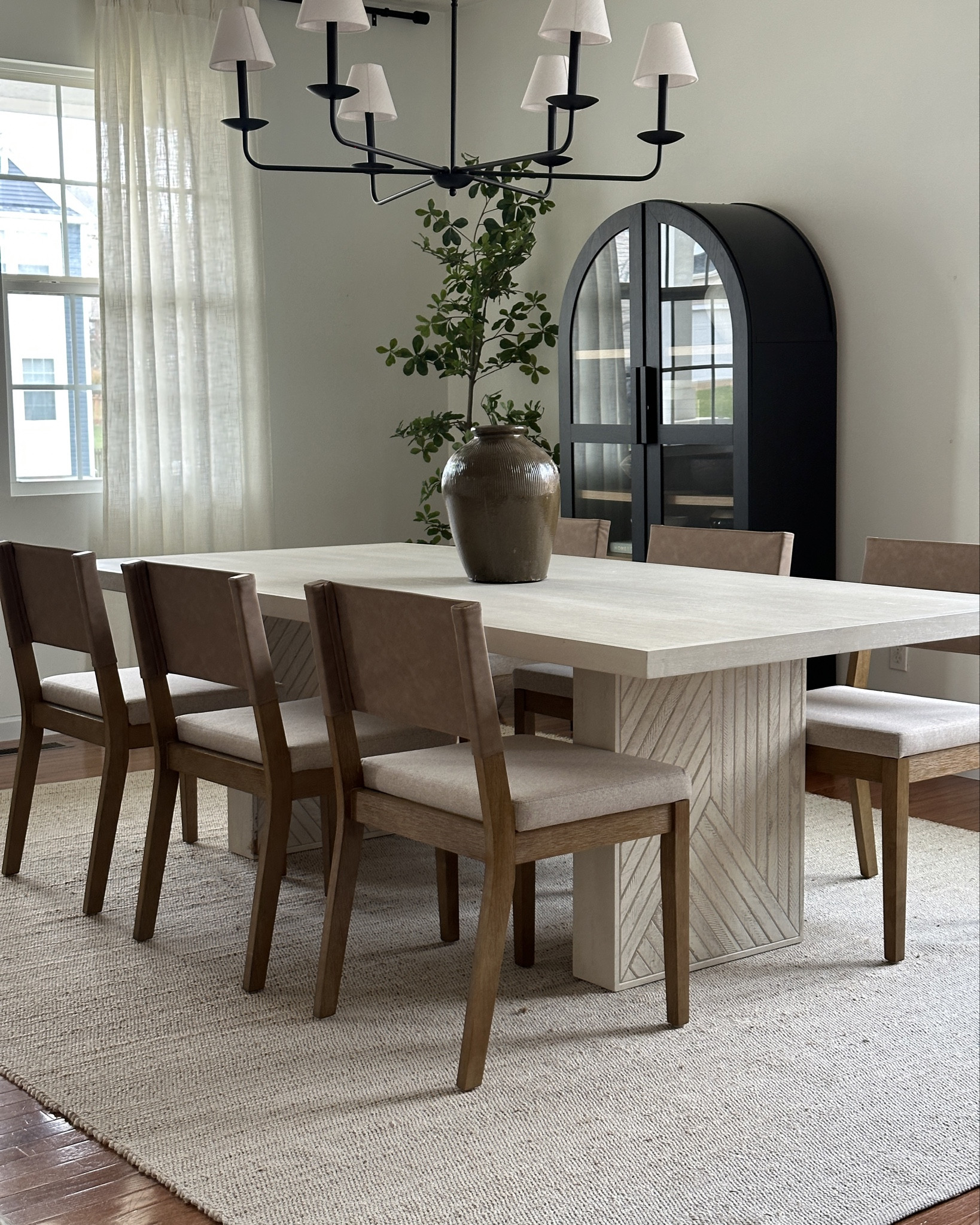 Same dining room, different chairs that totally change the feel of the room! 
Both are great quality. The brown have a leather back and taupe cushioned seat and a beautiful wood tone and lean into a more classic vibe.
My tendency is to be drawn more towards light and bright like the lighter wood and linen curved dining chairs! I’ve had these for a while now and love them. 
As always my black arched cabinet is the perfect accent piece, but my dining table (crate and barrel but no longer sold in this size) is the real MVP.

#LTKHome