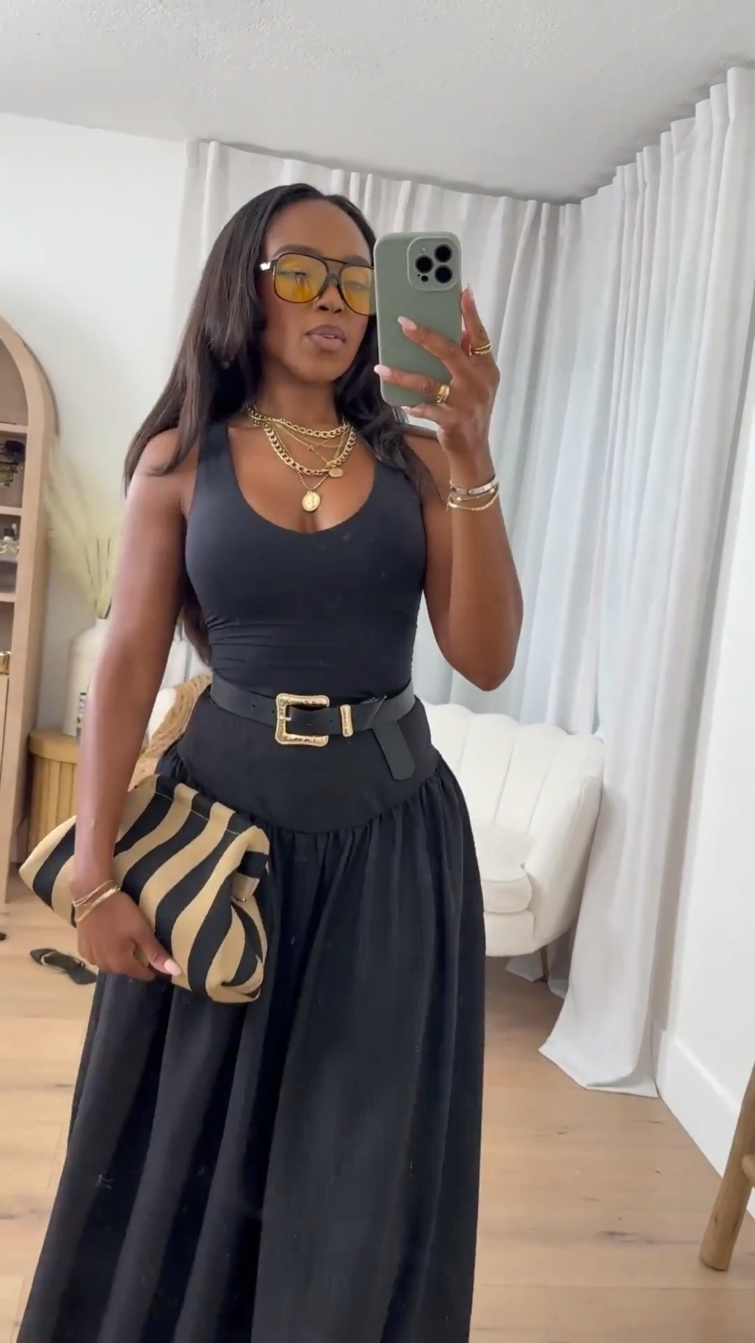Hi Babes!

This look is proof that an all-black outfit never fails. The fitted tank paired with this dramatic flowy maxi skirt creates the most beautiful silhouette, and the statement belt adds just the right amount of structure. I love how the striped clutch breaks up the monochromatic look while still keeping everything elevated and chic.

If you're petite and curvy, this outfit is incredibly flattering because the fitted top highlights your waist while the volume of the skirt creates gorgeous balance. The high-waisted skirt elongates the legs and gives that effortless luxury aesthetic that's always in style.

Where to wear this:
• Dinner dates
• Summer vacations
• Resort dinners
• Girls' night out
• Wine tastings
• Brunch with friends
• Special occasions

Undergarments: Nude seamless bra and seamless brief for the smoothest fit.

Everything is linked below.

xx Kira | IG: KirasFashionFinds

34D - 27 - 40 • Size Small or 4

Follow me on Instagram and YouTube @kirasfashionfinds

#LTKgrwm #LTKootd #LTKvlog