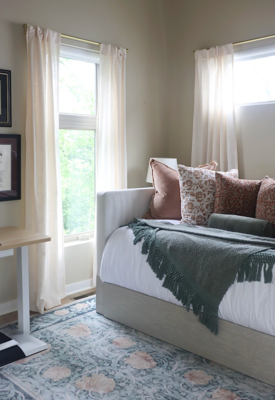 This guest bedroom and bathroom makeover is proof that cozy and functional can go hand in hand.✨ Designed for both rest and productivity, the space blends soft greens, warm rust, and earthy terra cotta tones to create a retreat that feels calm, collected, and full of character. We added a comfortable trundle bed, a work desk, and thoughtful details to make the room inviting yet practical for everyday use. The adjoining bathroom mirrors the same warmth with soft, saturated tones that feel both colorful and grounded. The result is a cohesive, soothing space that’s perfect for guests — and for work-from-home days.🌿🧡 

 #bedroomdesign #earthytoneinteriors #cozyhome #LTKU #LTKHome #LTKFamily