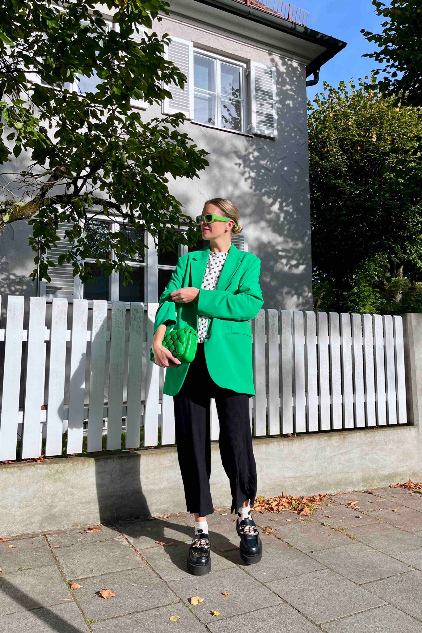 Polka Dot Pattern. Fashion Blogger Girl by Style Blog Heartfelt Hunt. Girl with blond sleek bun wearing a polka dot pattern top, green oversized blazer, green sunglasses, green braided bag, black pants, polka dot pattern socks and chunky loafers. #colorfuloutfit #colorfulstyle #colorfulfashion #colorfullooks #fashionfun #cutefalloutfit #fallfashion2023 #falllookbook #fitcheck #dailylooks #dailylookbook #contentcreator #microinfluencer #discoverunder20k