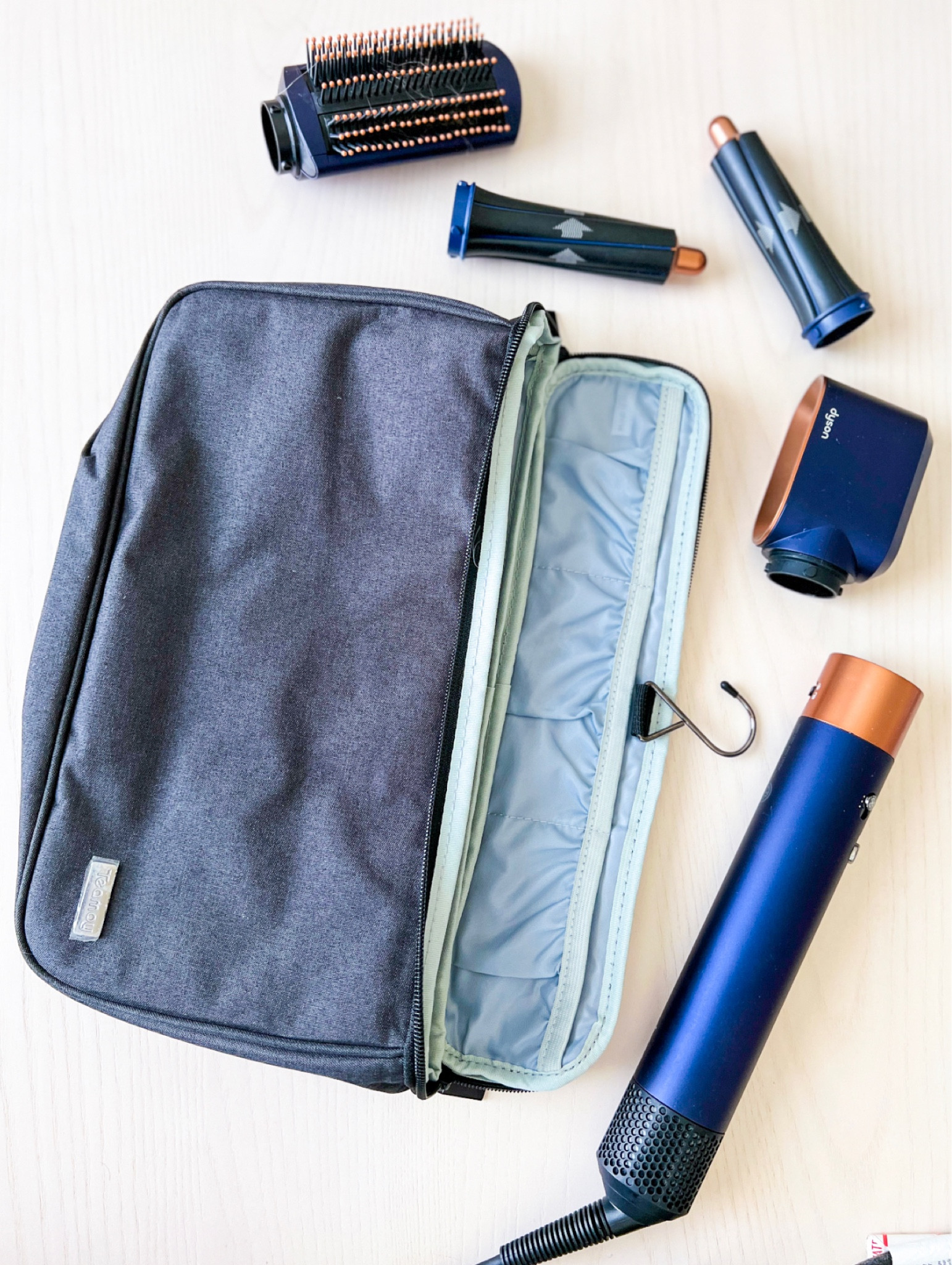 Dyson air wrap styler travel case - has hanging hook and compartments inside for different dryer attachments 

#LTKtravel #LTKsalealert #LTKbeauty