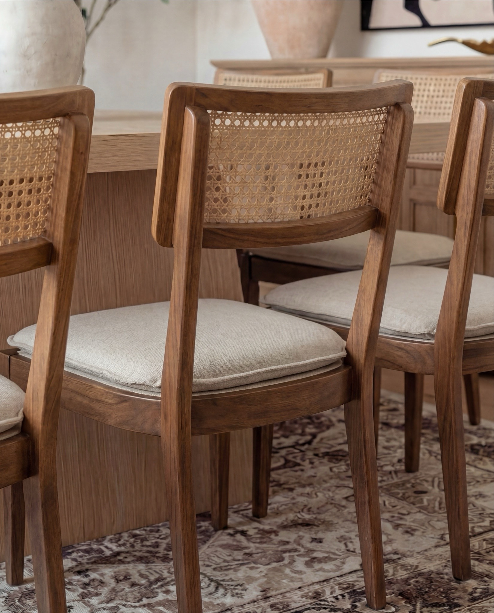 Shop the Look:
• Light oak rectangular dining table
• Cane-back wood dining chairs with neutral seat cushions
• Neutral vintage-style area rug (taupe + brown tones)
• Brass modern chandelier with curved arms
• Large ceramic vase with greenery stems
• Wood sideboard buffet cabinet (natural oak finish)
• Textured ceramic floor vase (warm beige)
• Brass wall sconces with tapered shades
• Abstract neutral wall art (black + cream tones)
• Wood arched cabinet or pantry storage
• Neutral linen table styling accessories
•Brass hurricane candle holders 
•brass tray
•Modern wall art
Faux tree
•Black tree planter
•Brass decorative  table all 
Brass decor tray and bowl
•Rug

#LTKHome #LTKSaleAlert