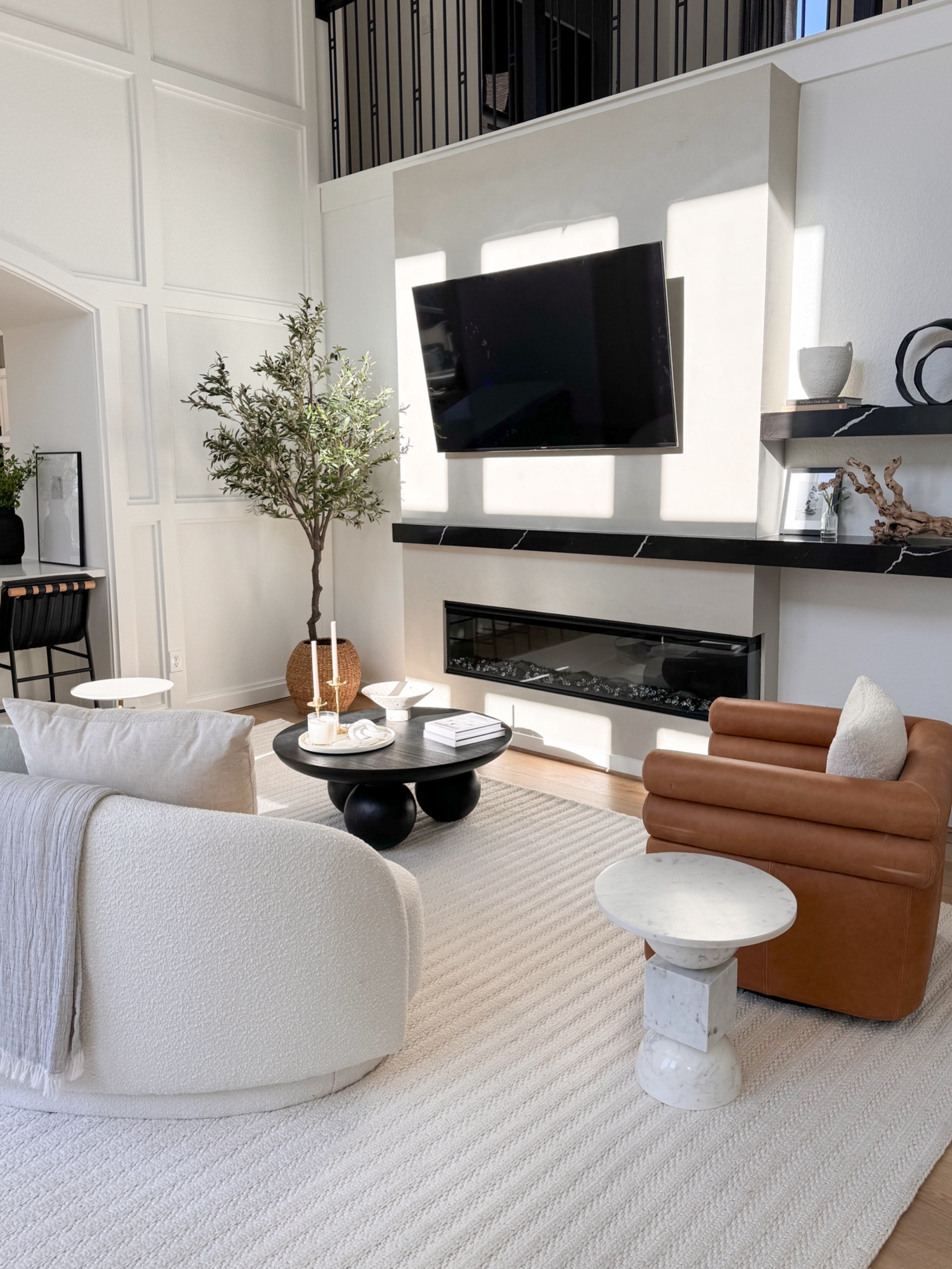 When I first walked into the model home of this floor plan- I IMMEDIATELY fell in love. I loved the openness, the size, the high ceilings, the “tucked away” kitchen, the large windows and natural light… I loved everything about it, but I knew I had to do something with that blank wall. I LOVE a cozy home so a fireplace was a requirement for me (I literally use it year round 😆). I told my designer @eliriahinteriors that I wanted to add a fireplace and she brought my vision to life! 

I am still in awe of how my silly little idea turned into THIS! Turning on the fireplace and lighting a candle after a long day of work is the highlight of my evening. And the black marble shelving, Roman clay and decor makes it feel even more like HOME. I really love it here 🤎

Electric fireplace, diy fireplace, living room, fireplacee

#LTKstyletip #LTKhome