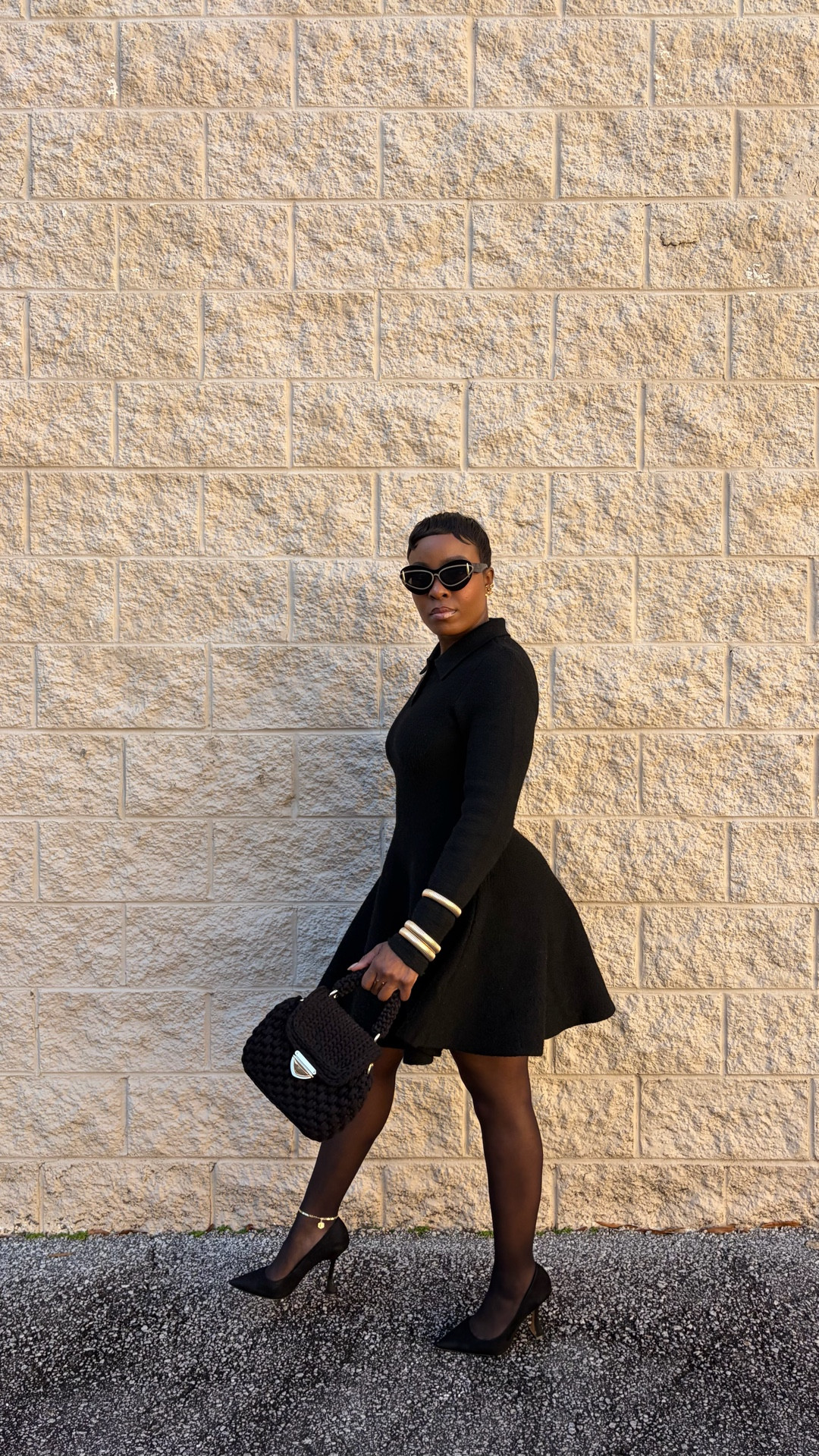 Black skater dress, winter fashion, chic black and gold outfit, black mini dress, gold bangles, knitted black purse