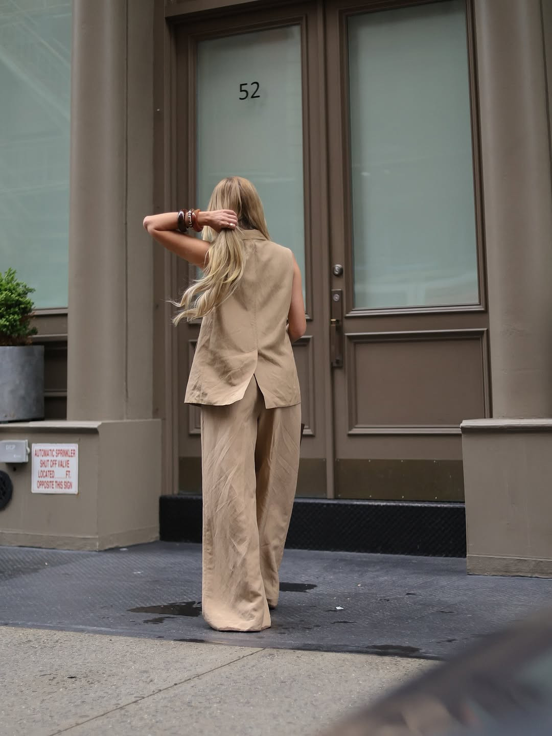 Modern minimalism in the city. This sophisticated tan vest set features a sleek back-split detail and flowing wide-leg trousers, styled with chunky resin bangles for an effortless street-style look. #CityAesthetic #MinimalistStyle #LTKworkwear 

 #LTKdayinmylife #LTKgrwm #LTKootd