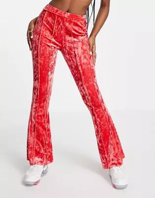 ASOS DESIGN crushed velvet flare pant with exposed seams in pink | ASOS (Global)