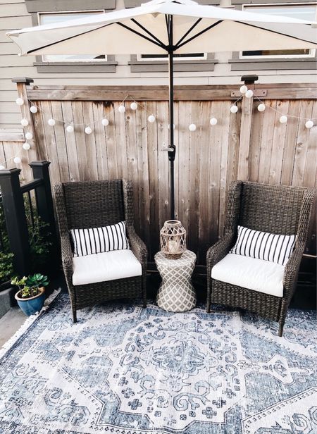 Similar Wingback wicker outdoor chairs, blue and white pattern outdoor rug, synthetic rattan pattern garden stool. Exact half round patio umbrella and stand.

#LTKSeasonal #LTKsalealert #LTKhome