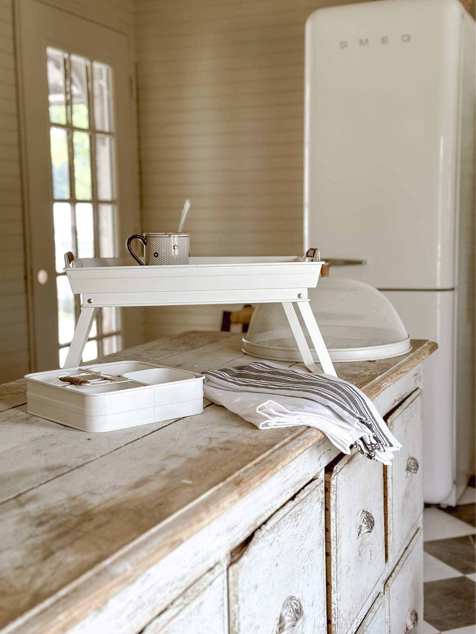 A MUST HAVE SUMMER FIND: a metal serving gray/tv tray/decorative tray with moveable legs. Perfect for serving, displaying, carrying, corralling, & so much more! 

#LTKhome #LTKFind