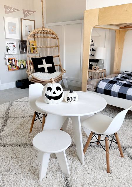Kids room with play table, reading corner, rattan swing chair, modern bunk beds and Halloween decor and books. 

#LTKfamily #LTKkids #LTKHalloween