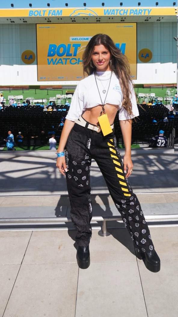 For the season opener against the Chiefs, I brought the fashion to the field. My statement piece? Black graphic denim from Akira with bold yellow smiley details (these turned heads + scored so many compliments at the stadium 👀). I paired them with a classic Chargers tee, styled my way by tucking it into a sports bra for that laid-back edge + just the right amount of skin.

Of course, no look is complete without sparkle — stacked my Melinda Maria favorites ✨ — and game-day essentials: oversized black sunnies + black platform boots. Both are ride-or-die staples for me on any stadium Sunday.

#LTKStyleTip #LTKSaleAlert #LTKSeasonal