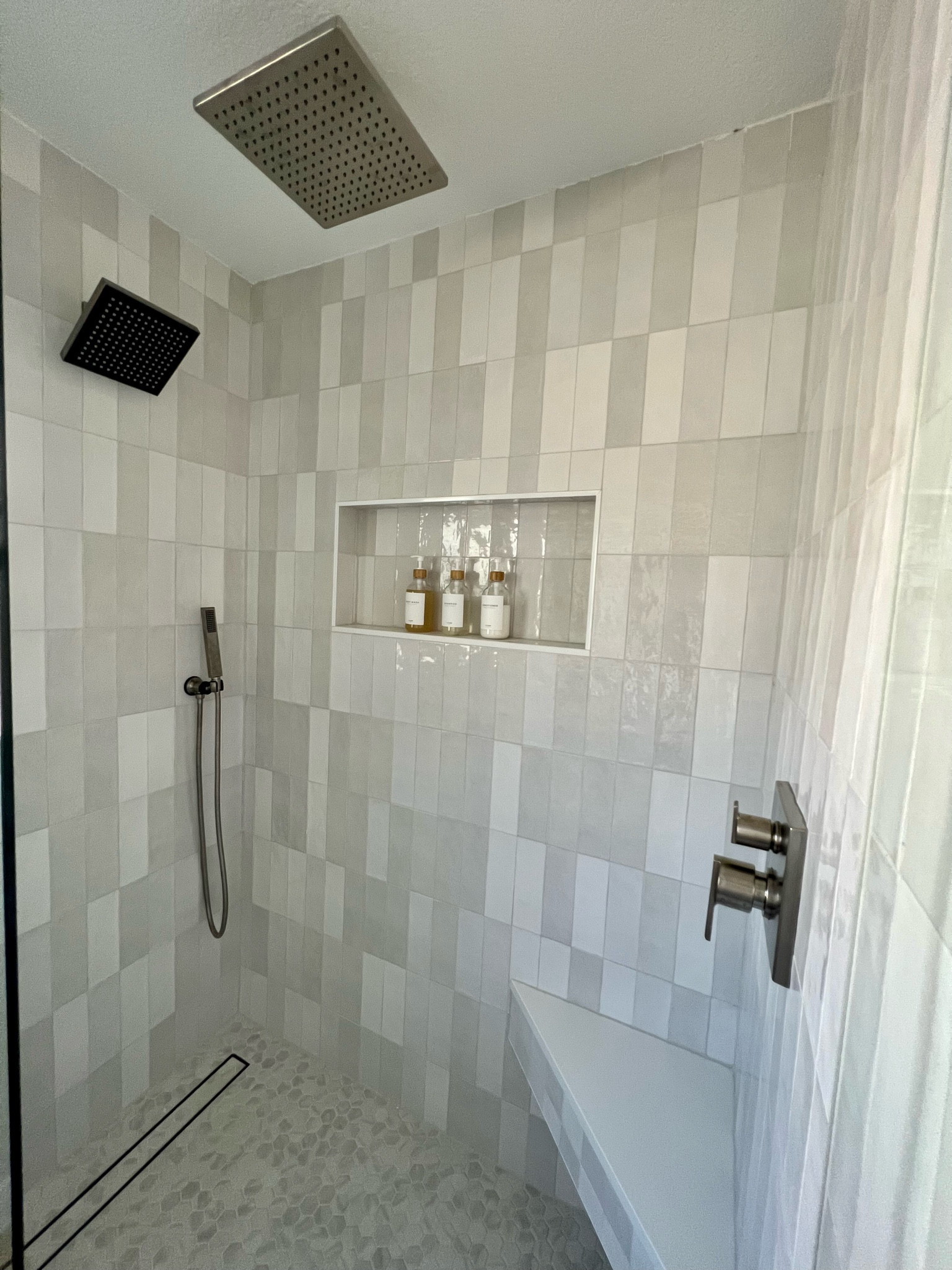 Shower Renovation! Saved thousands by shopping for the fixtures on Amazon! All shower heads, diverter and pump dispensers linked!

For the wall tile we went with Boutique Ceramic French Canvas 3-in x 9-in Glazed Ceramic Subway Wall Tile from Lowes. It is a Cloe dupe for a more affordable price! 

The floor tile is Style Selections Bianco Carrara 10-in x 12-in Matte Ceramic Hexagon from Lowes. 

#LTKhome #LTKfamily #LTKsalealert