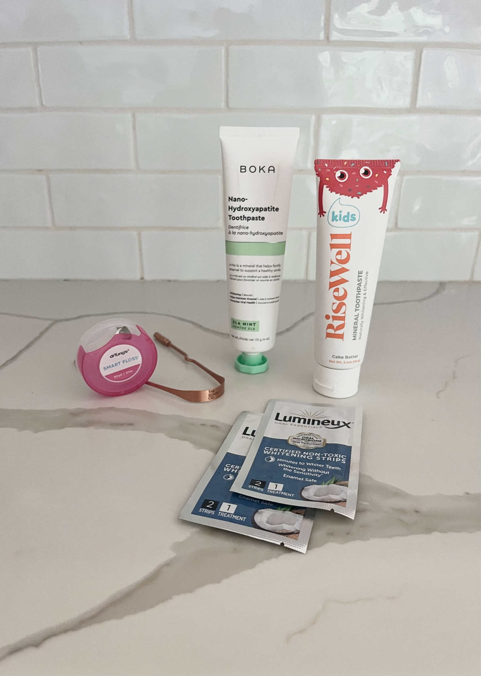Clean dental routine!  
👉🏼We use hydroxyapatite ingredients instead of fluoride. My daughter uses rose well and we use Boka. 
👉🏼 did you know that standard dental floss is full of plastic and PFAS?! This Dr Tungs floss is naturally free of allergens & free of BPA, PTFE, and petrochemical wax
👉🏼 tongue, scrapers are a must in your dental routine, it helps with lymphatic drainage and freshen breath. Your mouth seriously feels so much cleaner afterwards, these copper ones are super high-quality. I use rubbing alcohol on a cotton ball to sanitize mine every few days.
👉🏼 these whitening strips are made with natural ingredients like coconut and lemon oil.  They are great if your teeth are sensitive too because they don’t contain harsh chemicals.

Non toxic oral routine 
Nontoxic toothpaste 
Fluoride free toothpaste 

#LTKHome #LTKFamily #LTKKids