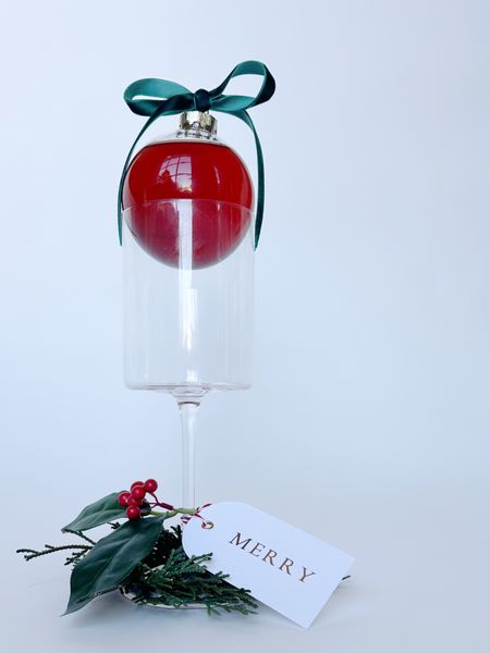 HOLIDAY COCKTAIL IDEA : pour your favorite festive cocktail into a glass ornament, tie a bow around the hanger and set it on top of a wine glass or any cocktail glass. it’s the most darling presentation as your guest arrive. Add a gift tag with the name of each guest to the base of your stemware. You can also put a mini napkin ring wreath at the bottom and a sprig of holly - makes a super cute party favor for them to go home with! 