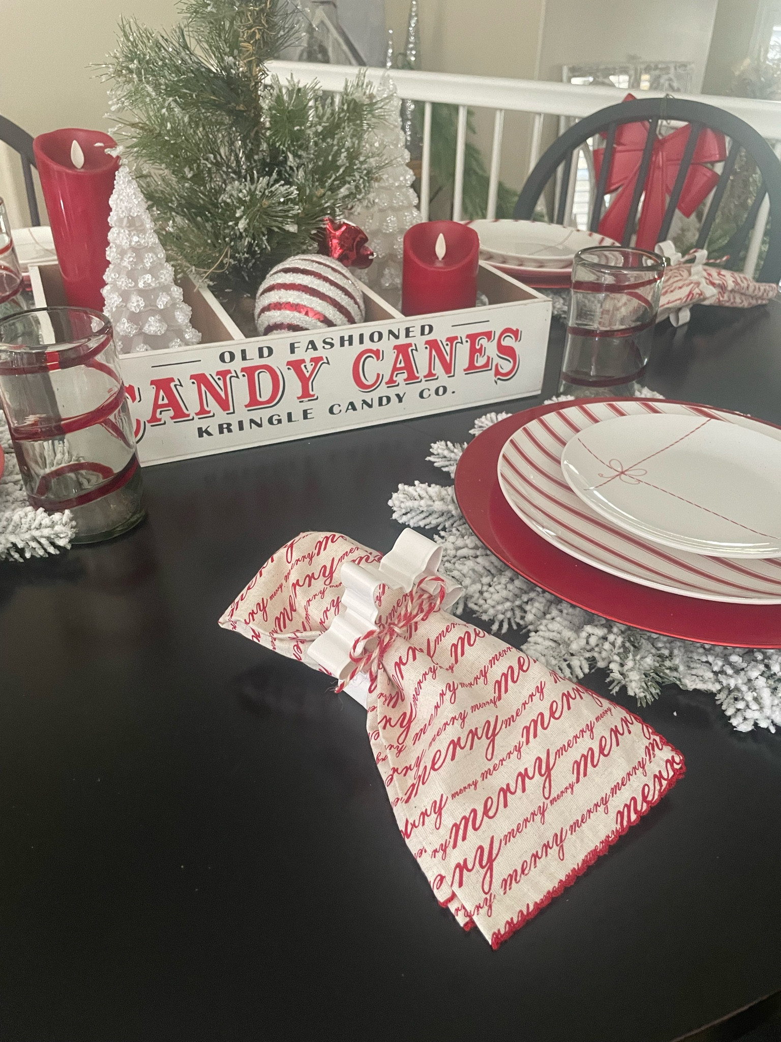 Christmas kitchen tablescape. We love these present dishes. We layered them over a red charger, set them on a snowflake placemat. We used a cookie cutter as a napkin ring and added pottery barn glasses. The center piece is cute candy cane crate with luminara flameless candles and Christmas trees  

#LTKHoliday #LTKSeasonal #LTKhome