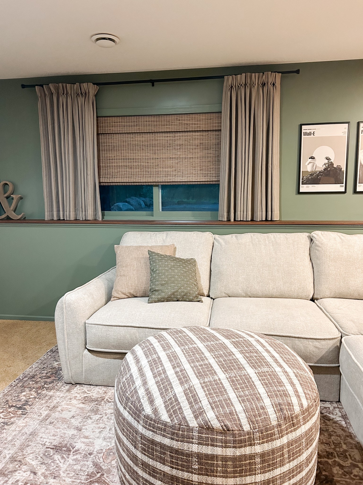 Basement Theatre Room, movie posters, cozy ottoman and rug 🍿 🎥 

Wall color is “dried thyme” by SW. woven shades are from select blinds, Linked in my “faq links” highlight on IG. 

#LTKHome