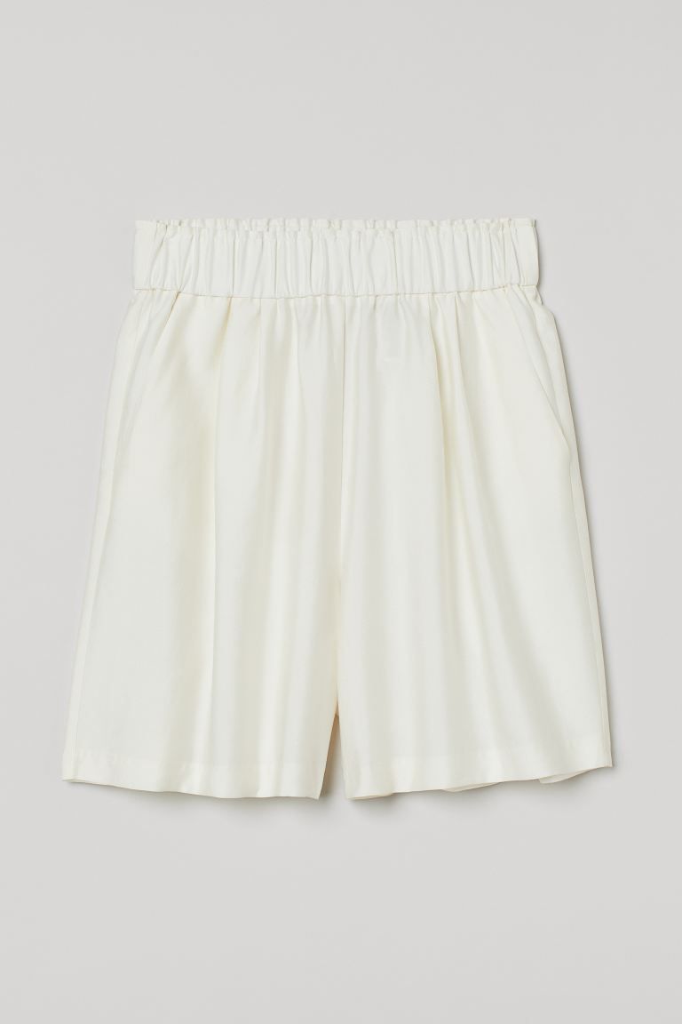 Conscious choice  Shorts in a woven linen, viscose, and lyocell blend. High waist, ruffle-trimmed... | H&M (US + CA)
