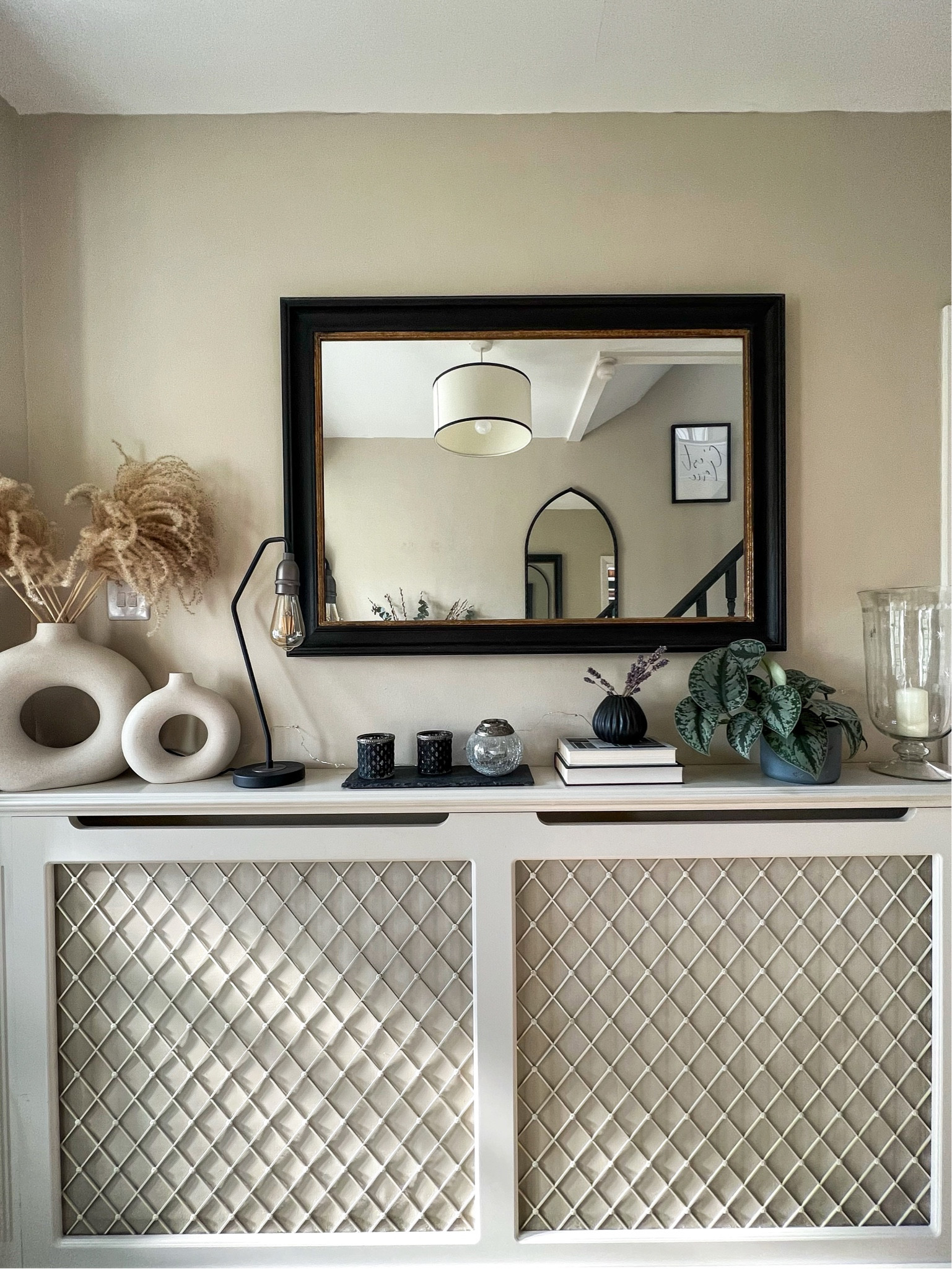 Hallway decor ideas including vases with dried flowers and pampas grass, black table lamp, large black and gold mirror, small black vase, tea lights for candle holders

#LTKhome #LTKstyletip #LTKeurope