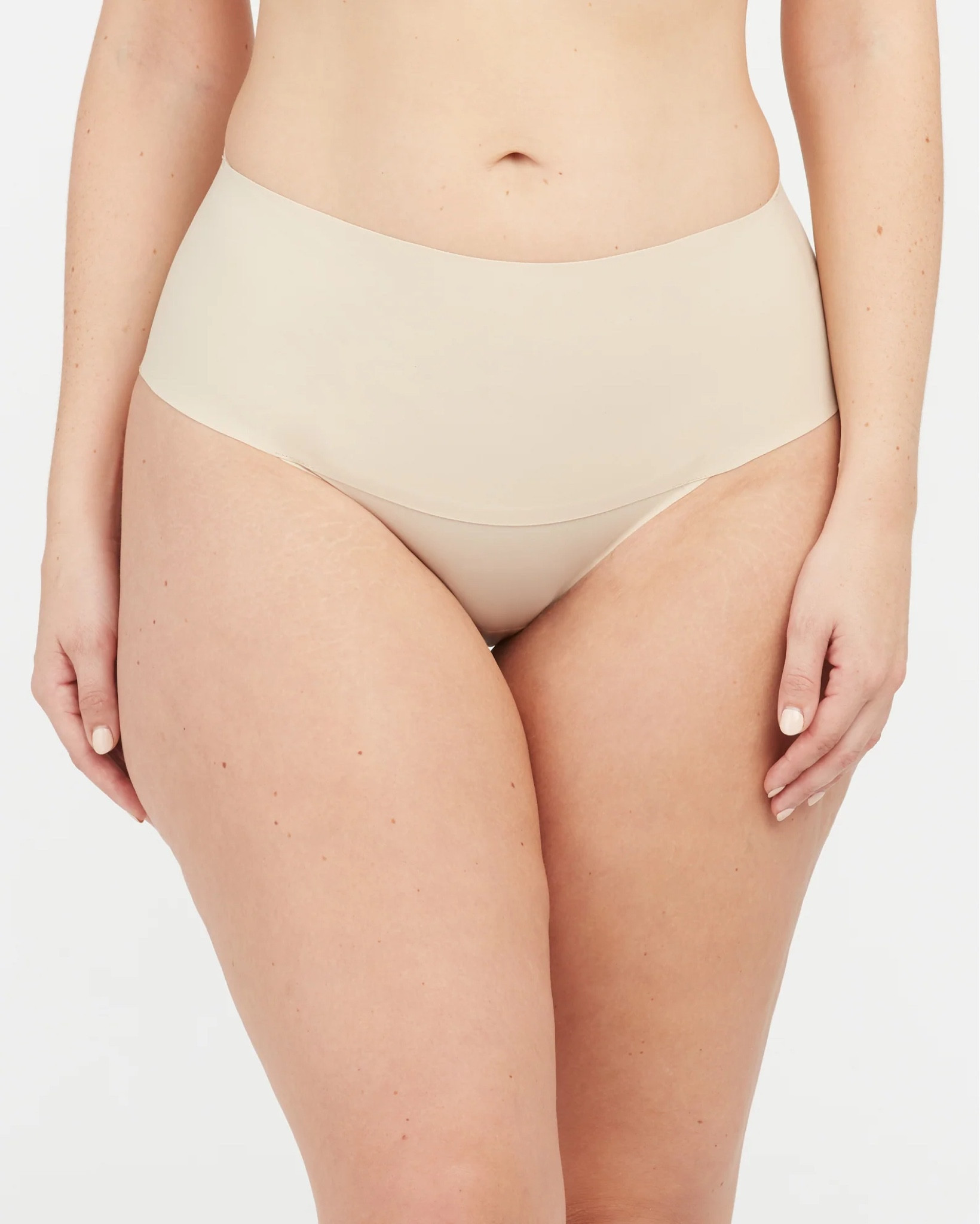 Spanx undie-tectable underwear. Great for apron belly compression. I wear a L and am size 12/14 in jeans. Could size down for even more compression! 