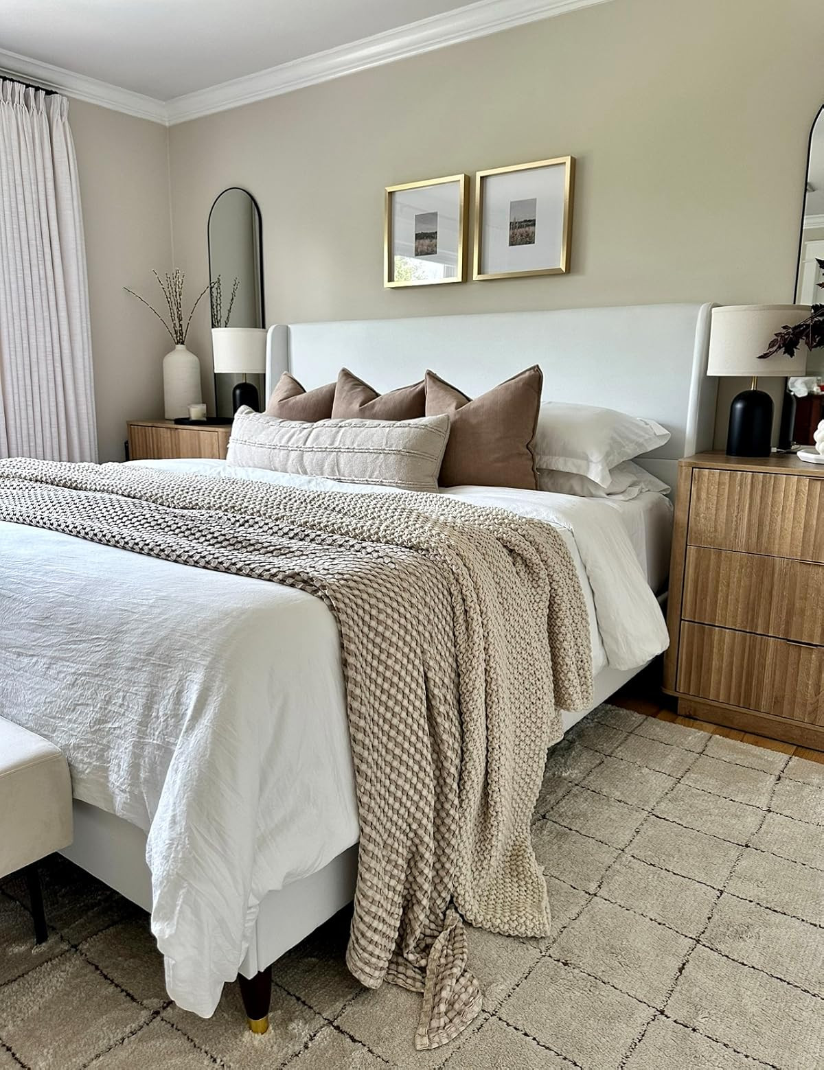 Bedroom on a budget inspo! Neutral cozy bedroom. Affordable bedroom. Fluted nightstands, upholstered bed, custom punch pleat curtains, neutral bedding, arch top mirrors, affordable pillows, soft neutral rug. | Amazon (US)