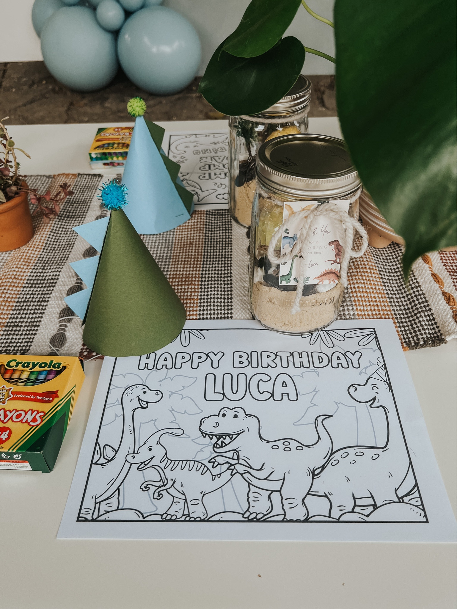 DIY dinosaur party favors with kinetic sand, toy trees, rocks, dinosaur bones, and dino egg bath bombs  

#LTKparties #LTKkids