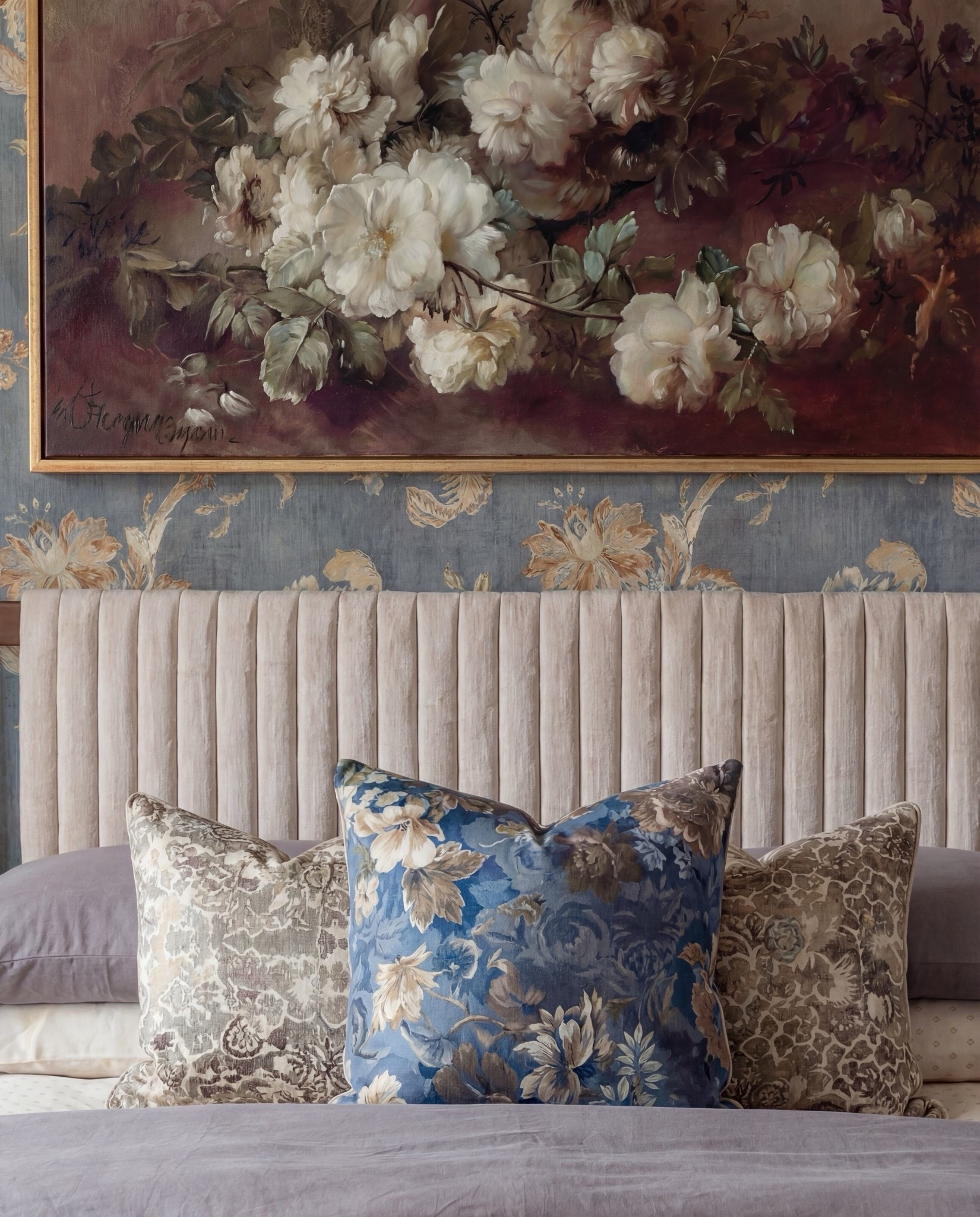 Shop the Look: Bedroom Refresh
• Warm-wood platform bed frame
• Vertical-channel upholstered headboard
• Gray duvet cover + layered sheet set
• Mixed blue + neutral accent pillows
• Oversized chunky knit throw blanket
• Shearling-style upholstered storage bench at the foot of the bed
• Pair of dark-wood campaign-style nightstands with brass hardware
• White drum-shade table lamps with blue glass bases
• Blue decorative bowls
• Bead garland décor
• Stack of books (nightstand styling)
• Framed oversized floral artwork above the bed
• Blue floral wallpaper (full wall + ceiling)
• Exposed wood ceiling beams
• Blue patterned area rug
• Window bench with plaid/tan accent pillows

#LTKHome #LTKSpringSale #LTKSaleAlert