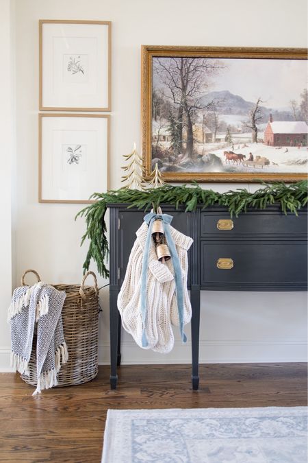 Hanging Christmas stockings on your buffet if you don’t have a fireplace. Real touch pine garland, velvet ribbons and bells  

#LTKhome #LTKSeasonal #LTKHoliday