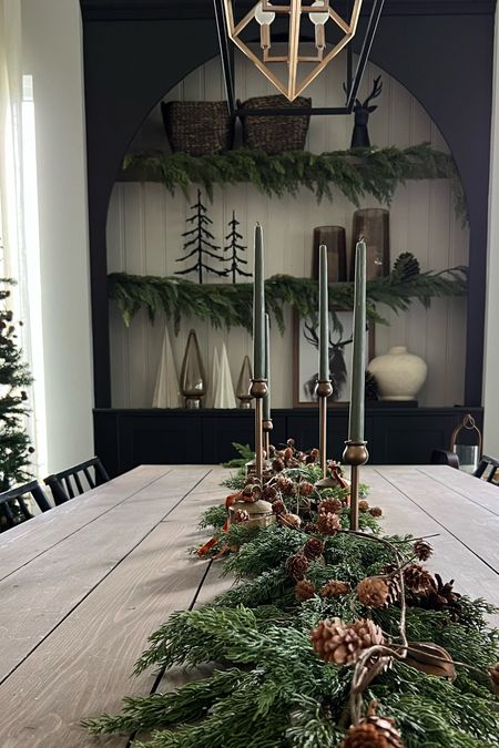 Dining table with faux cedar garland. Love the combination of greenery with the warm brass candlesticks! 
Christmas home, holiday decor 

#LTKSeasonal #LTKhome #LTKHoliday