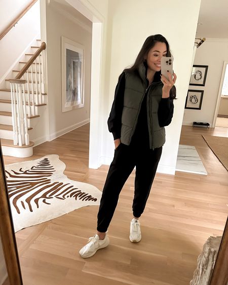 Kat Jamieson wears a jogger set and puffer vest with sneakers. Casual outfit, winter outfit, neutral style. 

#LTKSeasonal #LTKtravel #LTKfindsunder100