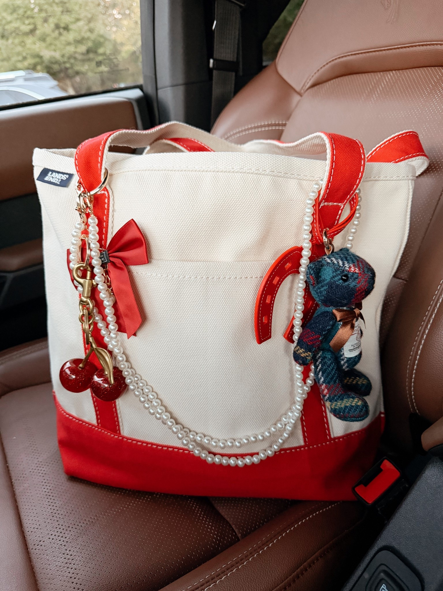 Purse of the day ❤️🍒
LL Bean inspired Canvas red tote 
Red bow bag charm
Coach inspired cherry bag charm for under $10
Harris tweed teddy bear charm
Red leather horseshoes purse charm
