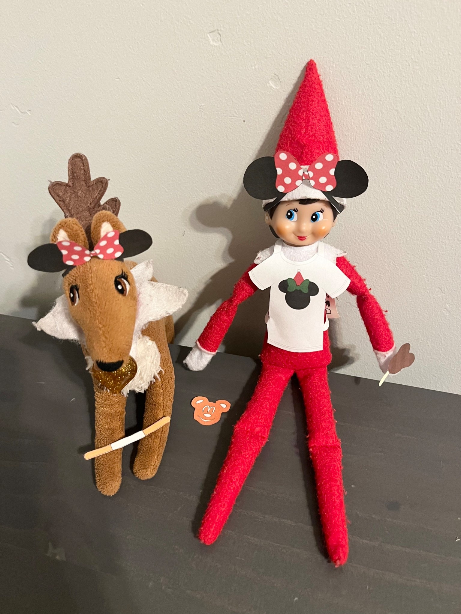 Our elf on the shelf and her elf pets reindeer are wearing Minnie ears, the elf has on a Minnie shirt, and they are eating a Mickey ice cream bar, a Mickey pretzel, and a churro. This is a fun Disney elf on the shelf idea!

#LTKHoliday #LTKmomlife #LTKSeasonal