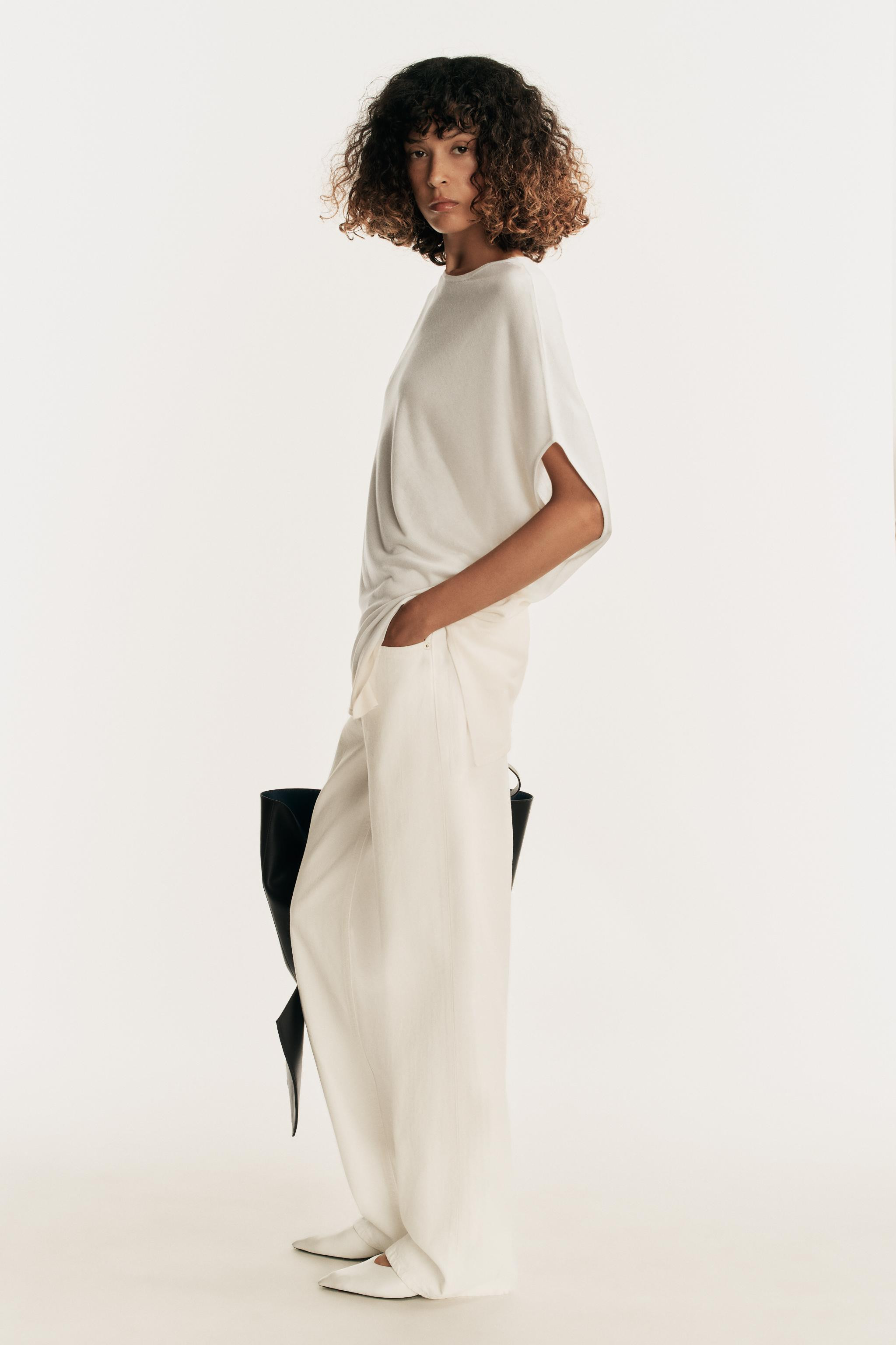 Flowy round neck top. Asymmetric sleeves and hem. | Zara US