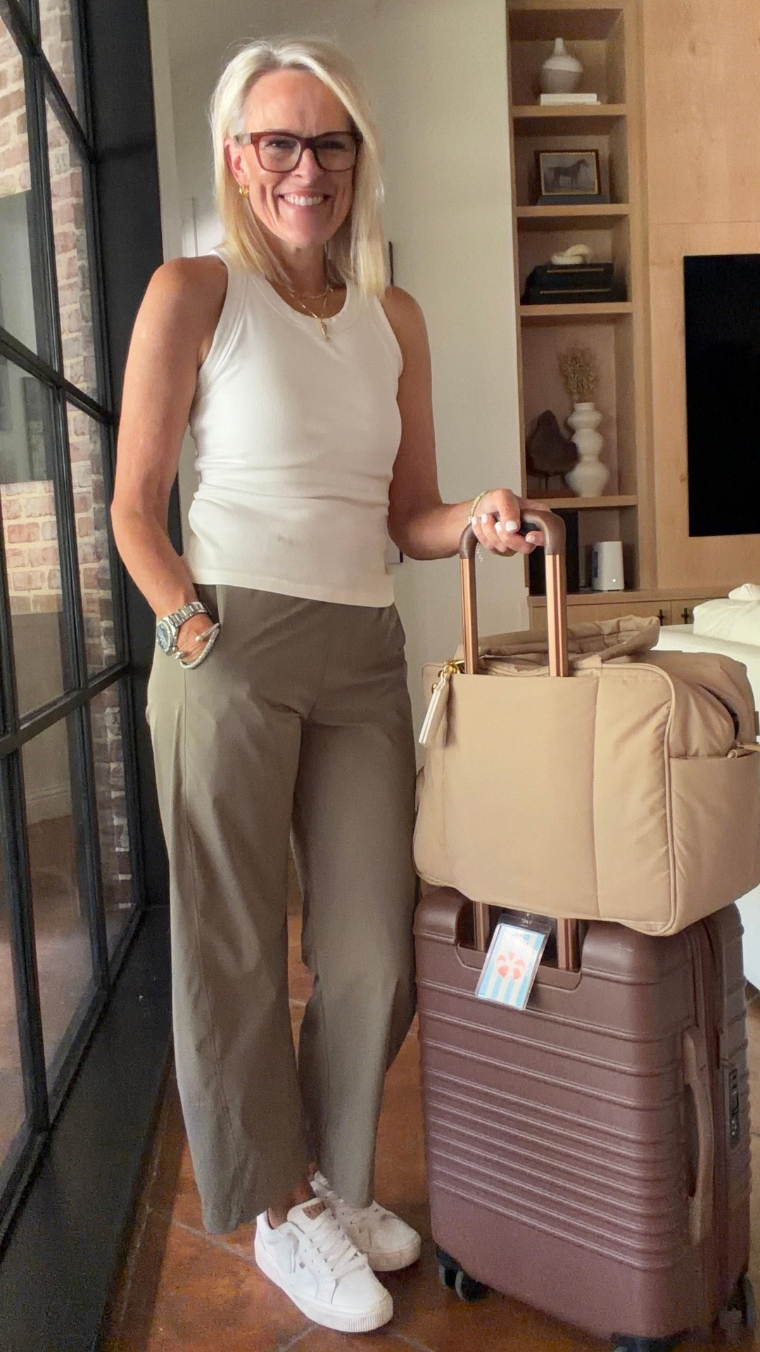 Comfortable enough for the journey and polished enough for wherever you’re headed 🤎 This is my easy travel-day formula for a flight, road trip, weekend getaway, or any out-of-town plans: a comfortable ribbed tank, relaxed pants, clean sneakers, and bags that can actually keep up with me.

The Luka Duffel + Large Check-In Roller are packed and ready to go!

💡 LTK MADE EASY
❤️ Heart = Support my posts!
🔖 Save = Get sale & restock alerts
📋 Lists = Keep favorites organized
📲 Share = Send lists and products to a friend. Hello, Christmas List!
💬 Comment = Ask me anything about what I’m wearing. :-)

#LTKootd #LTKOver40 #LTKTravel