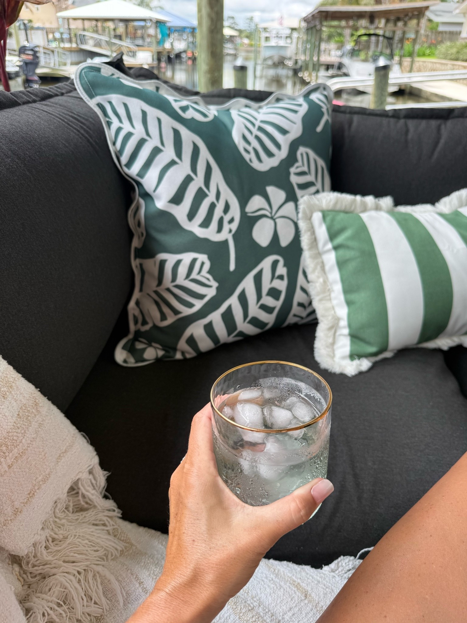 Dock sitting 
Outdoor living patio furniture outdoor pillow covers modern tropical coastal decor green striped pillow with fringe scalloped dark green palm pillow cover with zipper 
Green and gold cocktail glass hand blown

#LTKHome #LTKSaleAlert #LTKselfcare