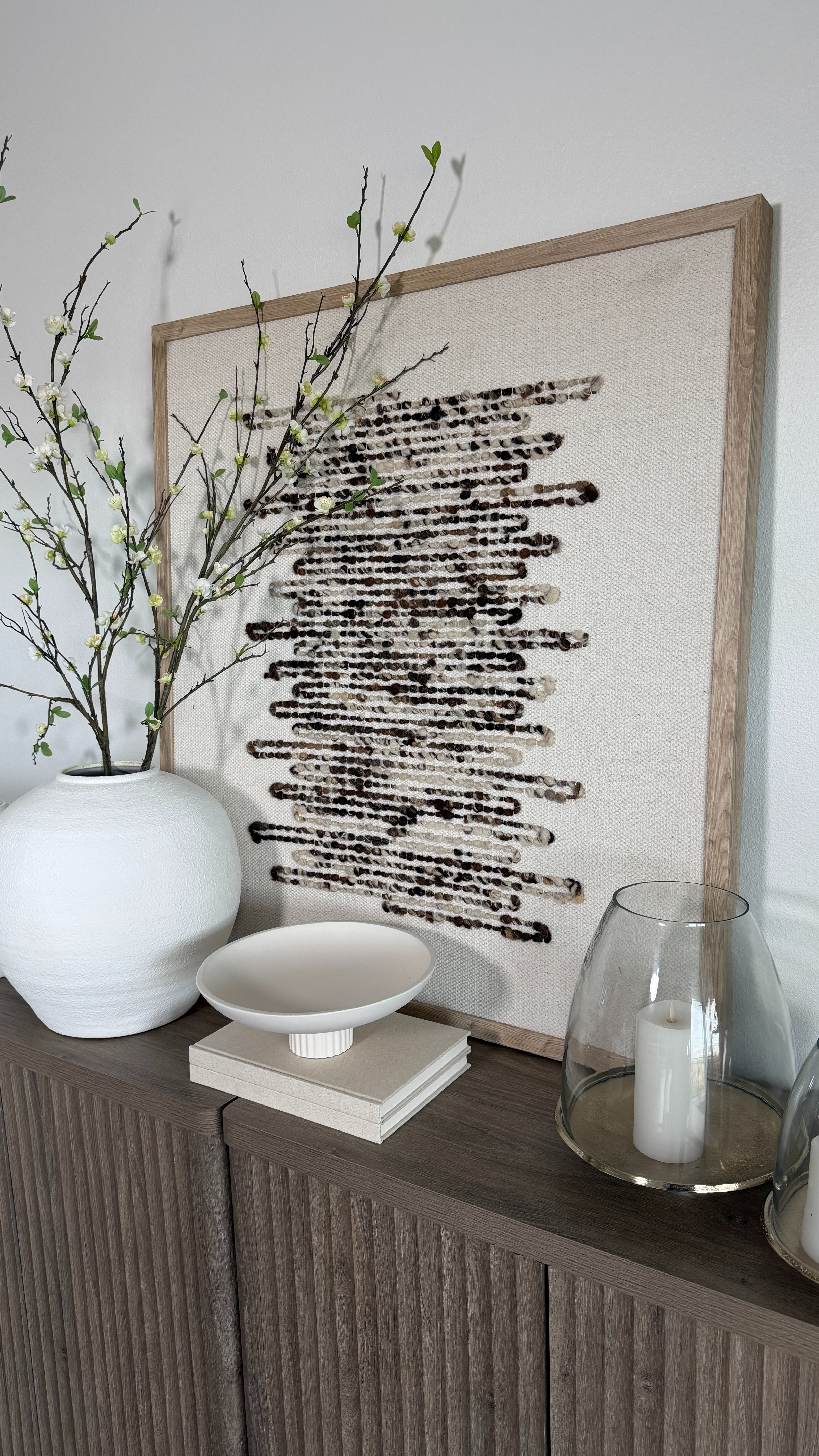 This stunning Wayfair art piece adds soft texture and a clean, neutral look that instantly elevates the room. The white vase, spring stems and vases help balance out the look.  

 #LTKHome