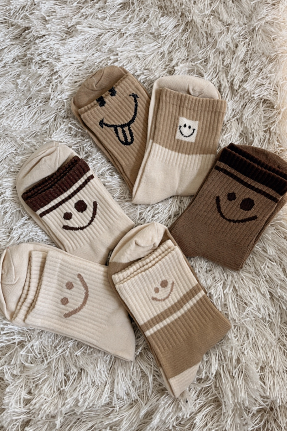 Smiley face socks 
Neutral socks

#LTKFind #LTKkids #LTKsalealert