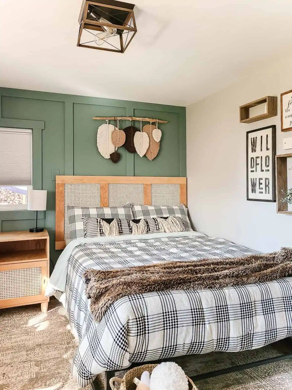 Cream and black plaid bedding against a green board and batten wall is a combo that just works. The cane headboard adds that warm, natural texture that ties the whole boho vibe together. Cozy without trying too hard.  

 #LTKHome