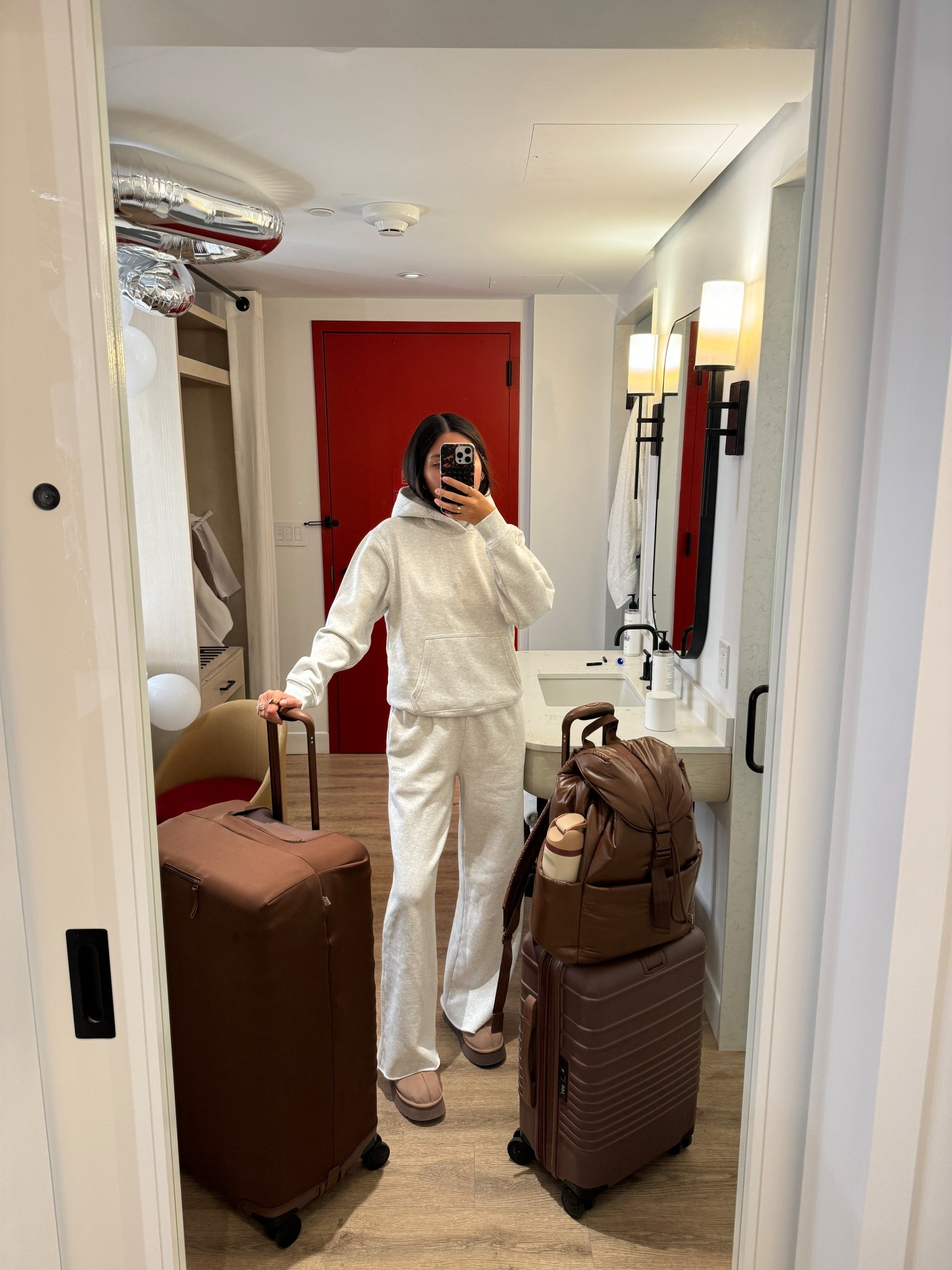 airport outfit, beis luggage, chocolate brown suitcase, carry on luggage, aritzia matching set, hoodie, aritzia joggers, travel outfit
