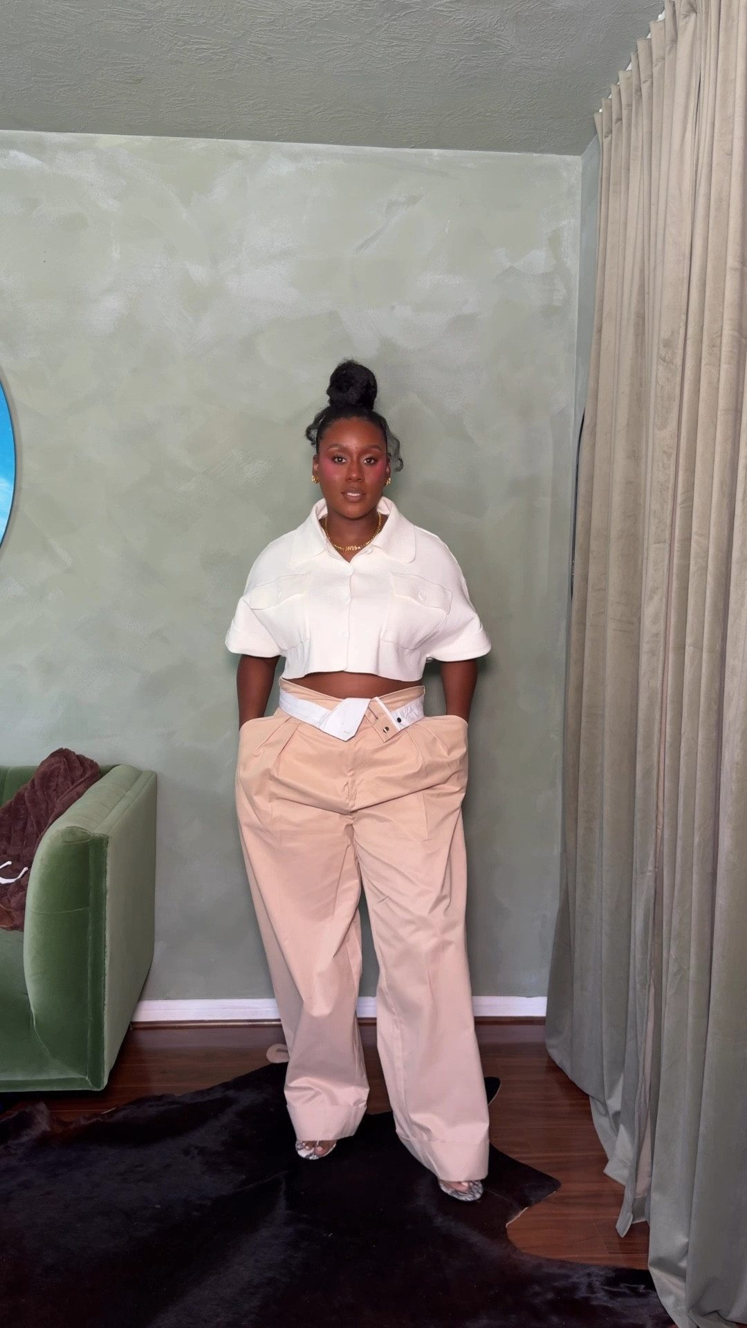 Fold over pleated wide leg pants with a cropped top and oversized clutch 