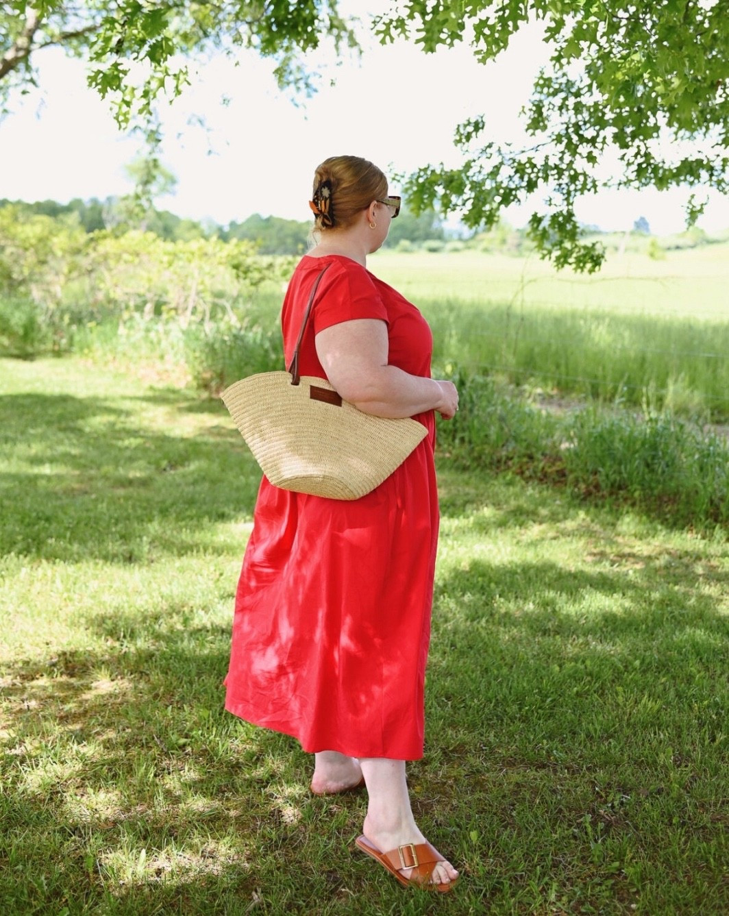 Sezane’s Justine Basket Bag ($285)  is a classic everyday woven handbag. It’s the perfect size for daily use and functions as a carryall that can fit a full size wallet, phone, and cosmetics, along with the occasional bottle of water, camera, or hairspray too.

The Justine also comes in a Mini size ($245) which makes for a cute – if novelty – occasion bag.

And if you’re someone who loves an oversize tote, then you might want to check out the Maxi size ($390) version. It’s a bit too big for me for everyday, but I love it as a travel bag or summer tote.

All three sizes of the Justine feature the same design: an interior drawstring pouch that’s sewn to the bottom of the bag, a woven shell exterior, a pair of short top handles, and a pair of longer shoulder straps.

The straps are really what make the bag so special because they give you lots of ways to carry it. You can carry the bag by its top handles, in the crook of your arm, or in your hand. And you can throw the longer straps over your shoulder for ease and convenience.

The bag itself is lightweight and effortless to carry, the straps are crafted from soft leather that sits comfortably on the shoulder and doesn’t slide off, and the minimalist design is neutral and versatile enough for everyday use. It’s truly the perfect summer bag, and given the classic design, it’ll be the perfect summer bag for years to come too.

#LTKSummerEdit 

#LTKPlusSize #LTKItBag #LTKMidsize