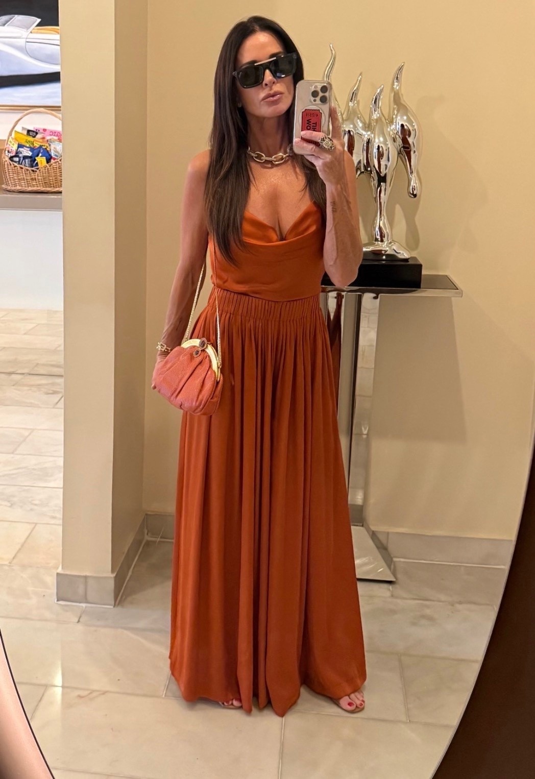 Kyle Richards wearing a sienna orange and matching ultra wide leg pull on satin pants ￼