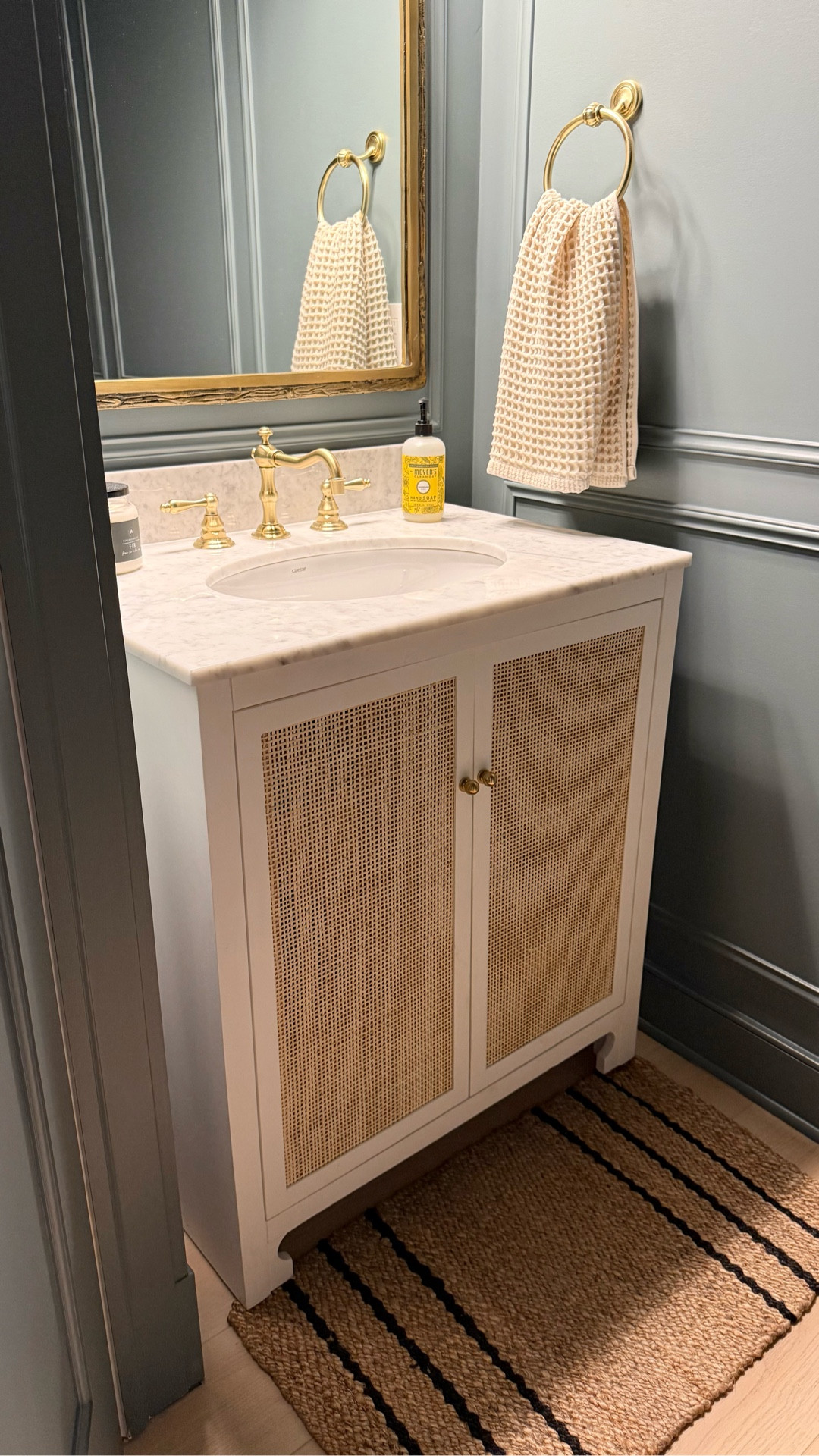 Moody powder room, cane bathroom vanity, brass bathroom faucet, brass vanity mirror, vintage wall art, powder room decor, waffle hand towel



#LTKSaleAlert #LTKHome #LTKFindsUnder50