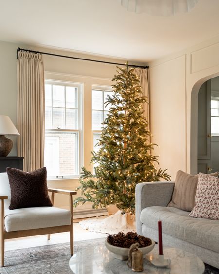 Living room decorated for Christmas with a 7.5 ft artificial Christmas tree with warm lights 🌲✨ #christmastree #christmasdecor 

#LTKhome #LTKSeasonal #LTKHoliday