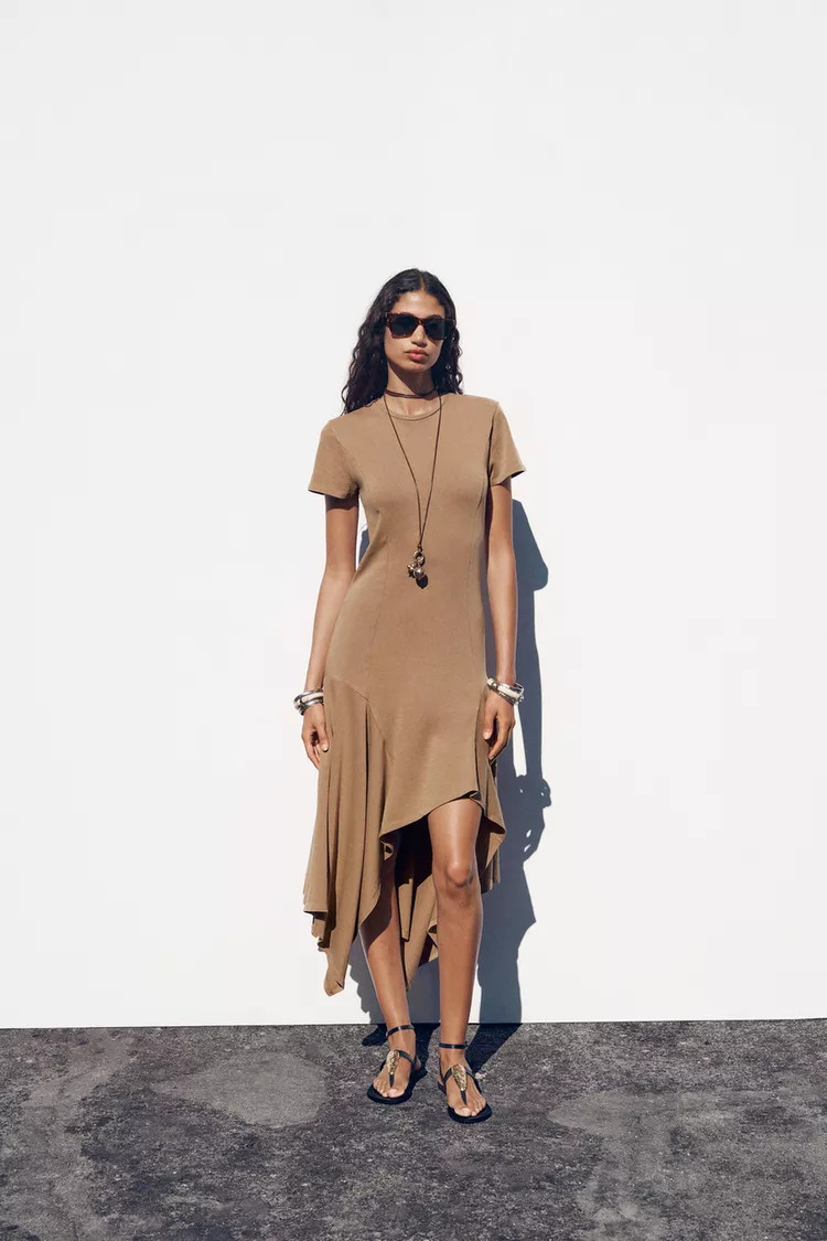 Long dress made of cotton yarn. Round neck and short sleeves. Asymmetric hem with volume.Dark tan... | Zara US