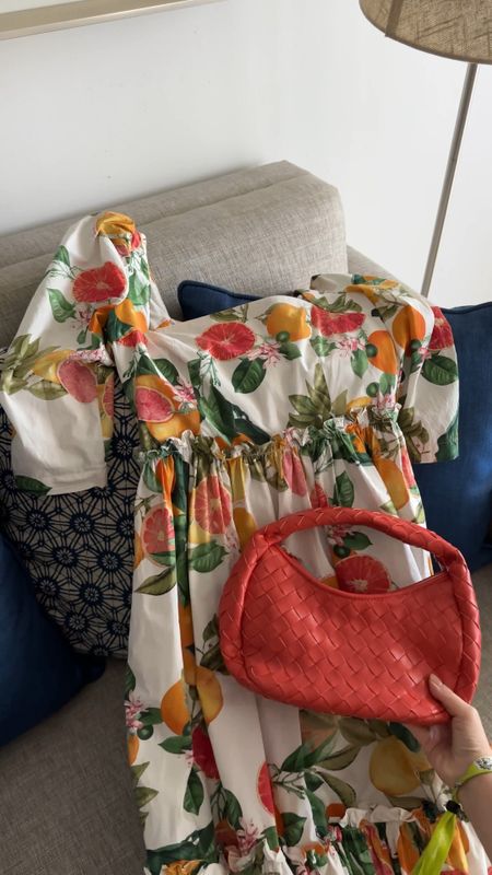 Tropical vacation outfit! Love this orange print midi dress, and found it on sale for 50% off. This coral braided bag is amazing, and perfect for Spring and Summer outfits

#LTKstyletip #LTKtravel #LTKSeasonal